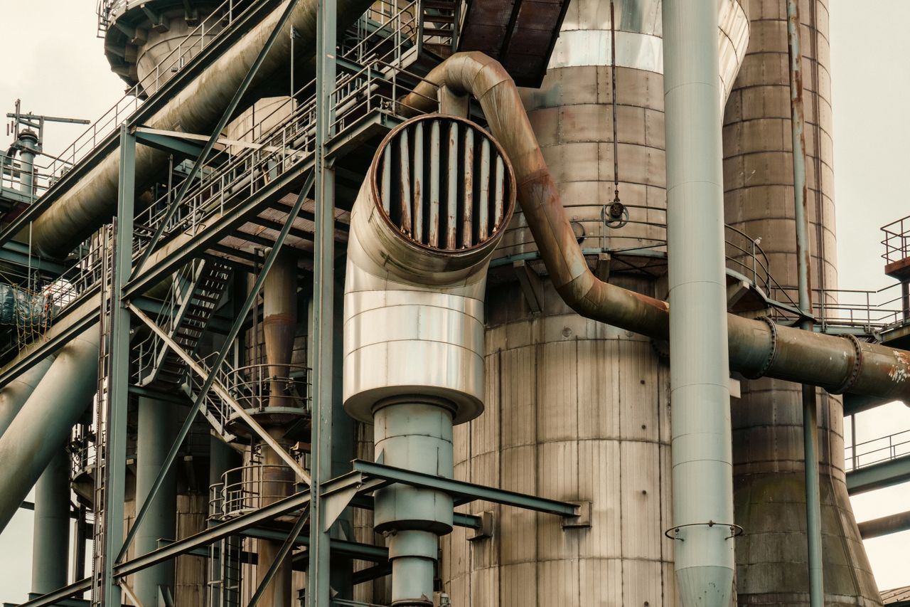 Industrial pipework, steel platforms and large cylindrical structures.